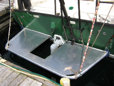 Hung off the back to get a feel. Device on ladder was raise-able depth sounder mount which will now need to be modified. <br />Note wavyness of transom.